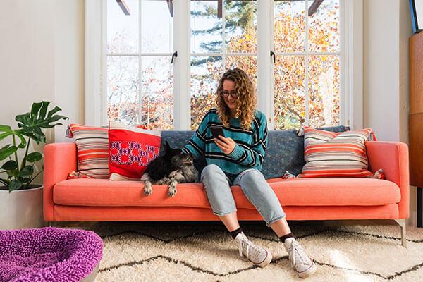 Girl with dog on couch